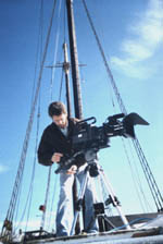 Tom Teich w /camera on ship deck